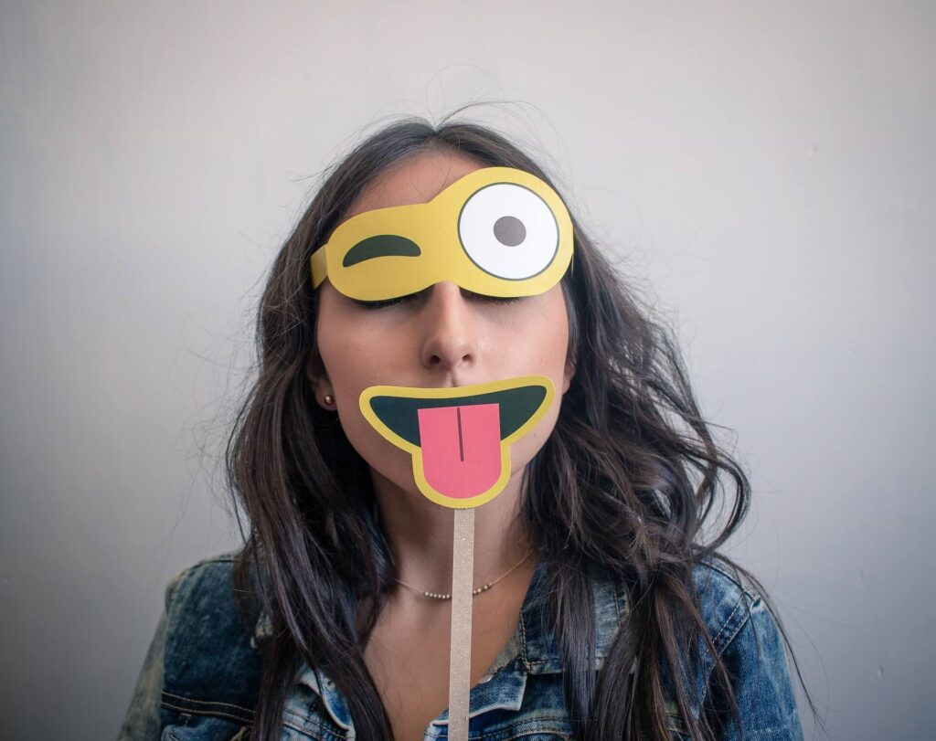 Woman with emoji cut outs - emoji marketing
